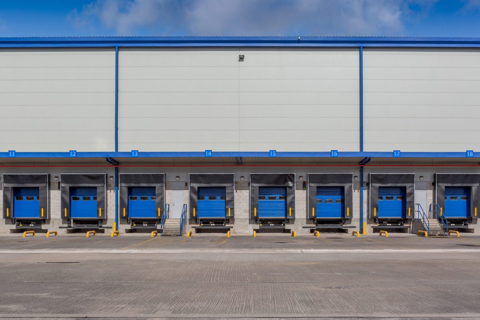 A large empty distribution warehouse with several loading bays