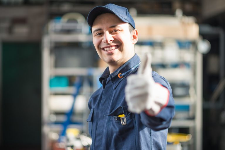 Smiling mechanic giving thumbs up